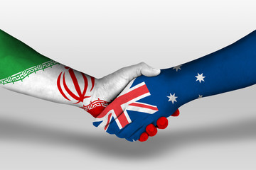 Handshake between Australia and iran flags painted on hands, illustration with clipping path.