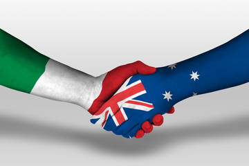 Handshake between Australia and Italy flags painted on hands, illustration with clipping path.