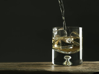 Glass of whiskey on a rustic wooden table, luxury drinks, space for text
