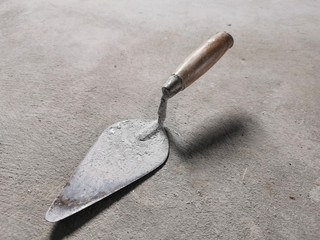 Trowel on cement background.