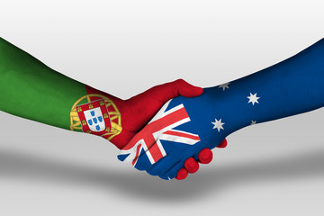 Handshake between Australia and Portugal flags painted on hands, illustration with clipping path.