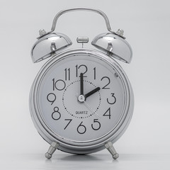 Silberner nostalgischer Wecker vor weißem Hintergrund