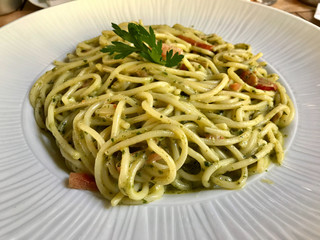 Green Pasta Spaghetti with Pesto Sauce in Big Plate at Restaurant. Ready to Serve.