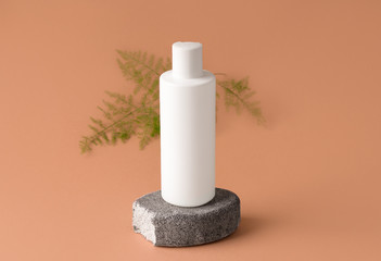 Mockup cosmetics. White bottle, on gray stone