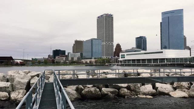 Pan Right from Mighan River Walkway Overlooking Downtown Milwaukee City Skyline