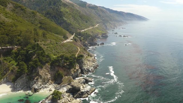 4K Aerial: Pan Up Reveals Dramatic Coastline in California's Big Sur with McWay Falls Waterfall in Background