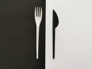 black knife and white fork isolated on black and white background