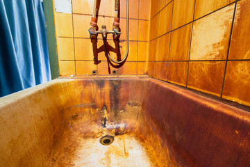 Rust stains in bathtub on wall and bath. High level Iron dissolved in a water. Ferrous Iron