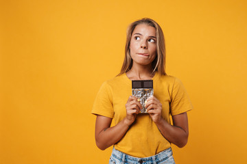 Image of blonde pleased woman smiling and holding chocolate