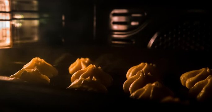 Warm fresh eclair in a bakery. Making bakery and eco production. Manufacturing process working hard. Bakery shop and selling sweets. Baking sweet tender eclairs in oven. Time lapse footage of cooking.