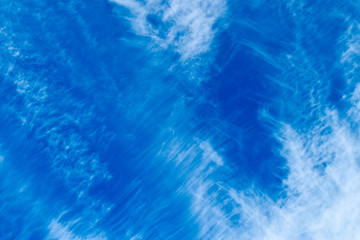 View of a blue sky with white clouds, blue background
