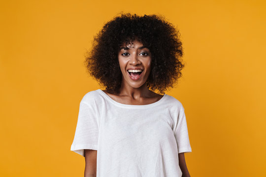Image of excited african american girl smiling and looking at camera