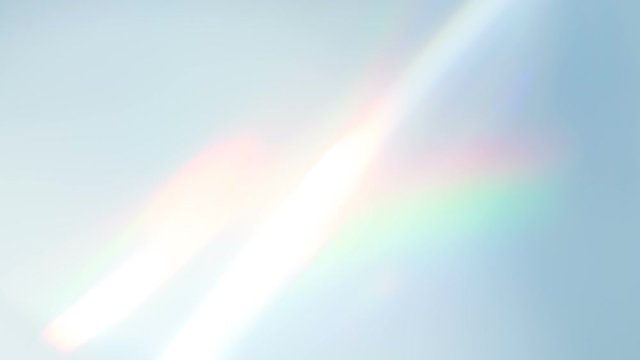 Diamond Creates a Bright Highlight. Loop. The light passes through the facets of a slowly rotating diamond and creates repetitive sparkling highlights and rainbow colors