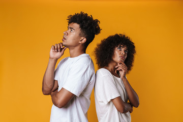 Image of resentful african american couple posing pack to back