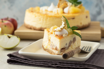 Caramel apple pear cheesecake. Close up side view stone kitchen table, side view. Autumn dessert. Woman decorated apple cake