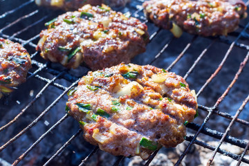 patties of ground meat on the cooking grate and food preparation. selective focus