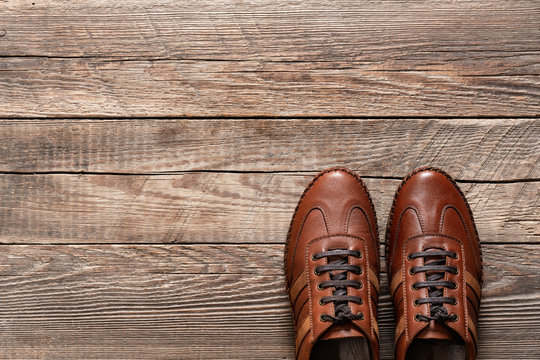 Leather sneakers on wooden background