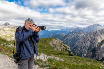 Mountain photographer taking pictures of the landscape