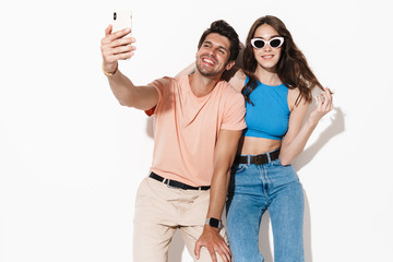 Obraz premium Image of attractive happy couple smiling while selfie on smartphone