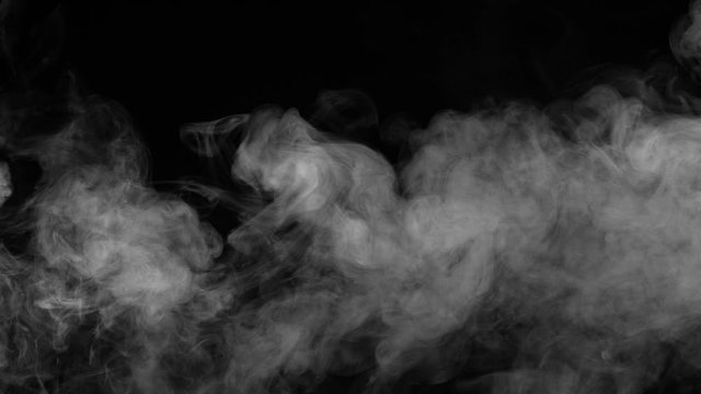 Smoke Curtain Slowly Flows. Remnants of white smoke slowly floating to the right clearing the black screen. Filmed at a speed of 120fps