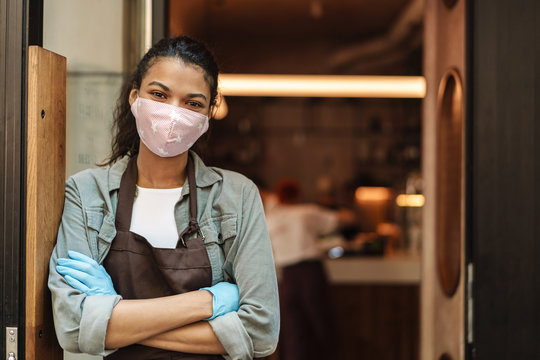 Woman cafe owner with face mask