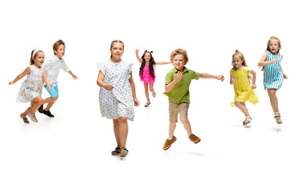 Happy children, little and emotional caucasian kids jumping and running isolated on white background. Looks happy, cheerful, sincere. Copyspace for ad. Childhood, education, happiness concept.