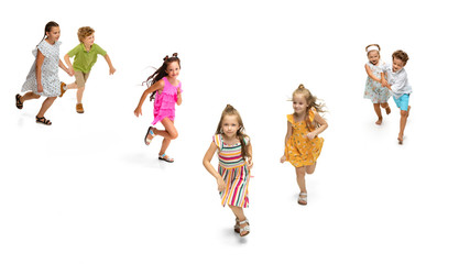 Happy children, little and emotional caucasian kids jumping and running isolated on white background. Looks happy, cheerful, sincere. Copyspace for ad. Childhood, education, happiness concept.