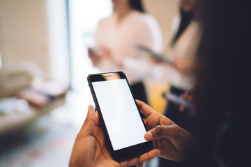 Black person browsing smartphone in office