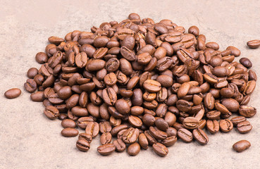 Roasted coffee beans on a textured background, empty copy space