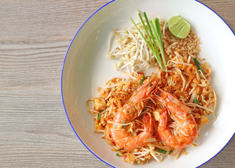 Thai Style Fried Noodle Called Pad Thai Topped with River Prawns Served on Wooden Table