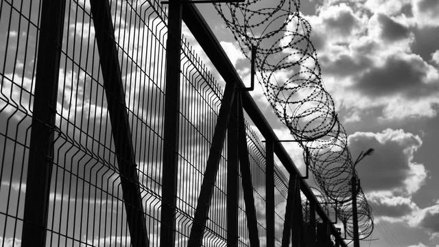 Prison fence with barbed wire
