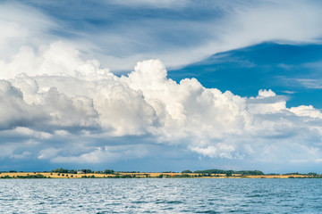 Dramatic cloud scape with windwheels on the Danmark coast of Flensburg Fjord near Sonderburg,...