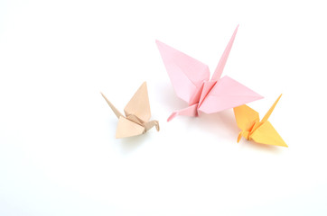 three colorful origami cranes on white