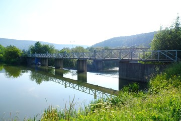 Bridge and dam on Krempna reservoir on sunny morning. Low Beskids Mountains, Poland