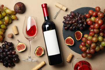 Composition with wine and fruits on craft background, top view