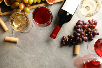 Composition with wine, grape and corkscrews on gray background