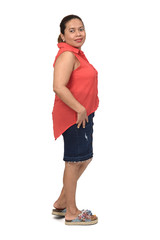 side view of full portrait of a woman with skirt on white background, looking at camera