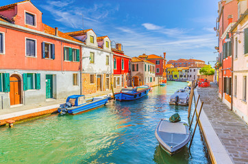 Murano islands with water canal, boats and motor boats, colorful traditional buildings, Venetian Lagoon, Province of Venice, Veneto Region, Northern Italy. Murano postcard cityscape.