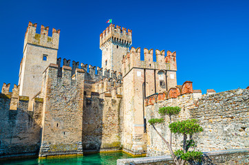 Obraz premium Scaligero Castle Castello di Sirmione fortress from Scaliger era in historical center of Sirmione town on Garda lake, medieval castle with stone towers and brick walls, Lombardy, Northern Italy