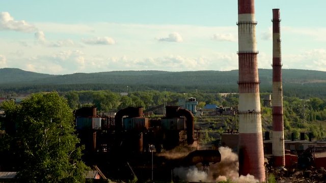 The collapse of an industrial chimney. Explosion of an old chimney of an obsolete metallurgical plant. Chelyabinsk region. Russia.