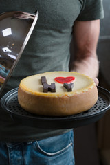 Cheesecake in man hands. Homemade cheesecake. New York style cream cheese cake