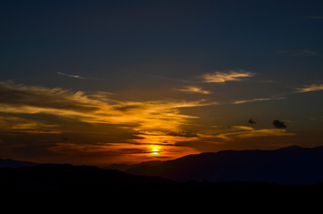 Panoramic view of the mountain landscape at sunset. Mountain silhouettes. View from Mount Tahtali near Kemer to Taurus Mountains, Turkey