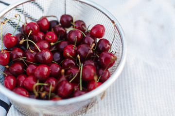 Red cherries in an aluminum bowl