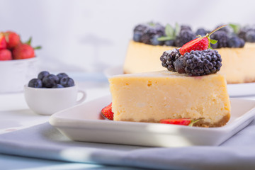 Blueberry mousse cake, cheesecake with fresh blueberry  on white plate with mint leaves