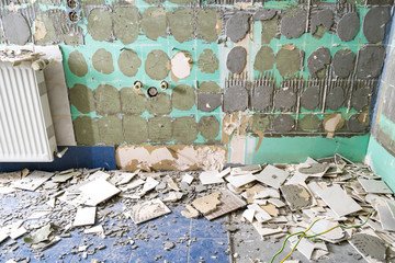 Pile of ceramic tiles remains after bathroom renovation prepared to be thrown into the trash