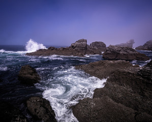Landscape of Belle-île-en-mer, Morbihan, Brittany / Bretagne, France. Rocks and cliffs at the coast on a foggy morning at la pointe des poulains. 