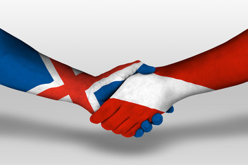 Handshake between austria and iceland flags painted on hands, illustration with clipping path.
