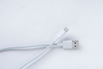 Fototapeta premium White USB Type C charging cable, compatible with many devices, wrapped isolated on white background. 