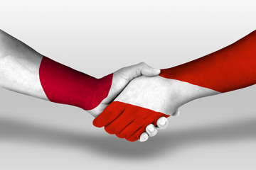 Handshake between austria and japan flags painted on hands, illustration with clipping path.