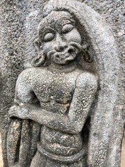 Fototapeta na wymiar Bas relief sculpture of an aged man carved in the walls of Shiva temple at Tamil nadu